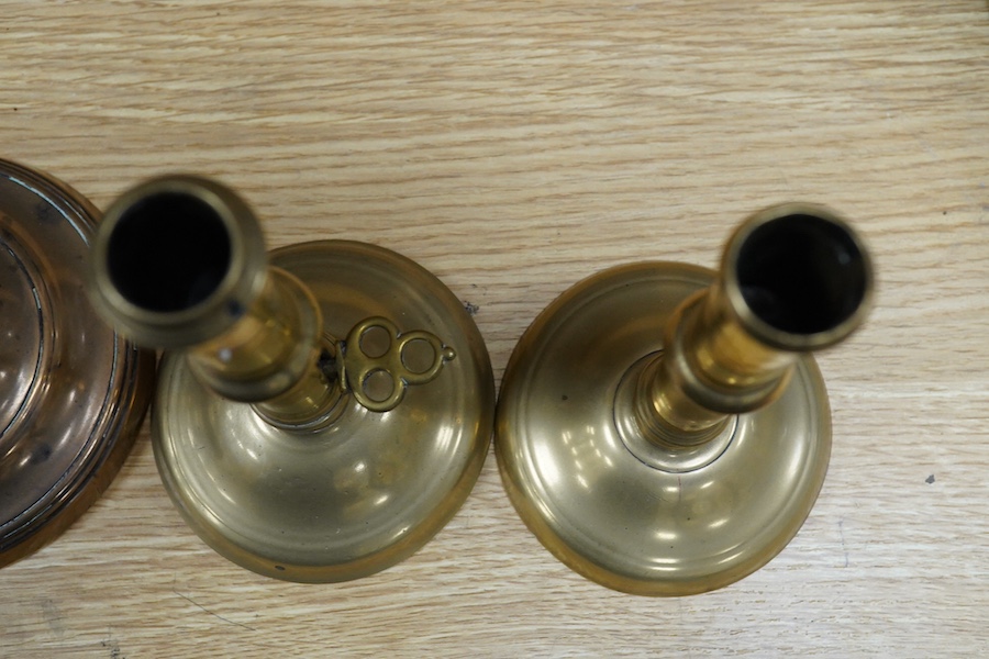 Two pairs of candlesticks to include 18th century brass ejector examples, 37cm wide. Condition - good